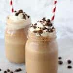 Coffee frappe in a mason jar topped with whipped cream.