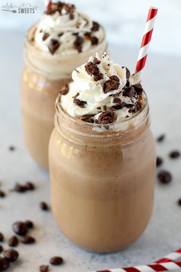 Coffee frappe in a mason jar topped with whipped cream.