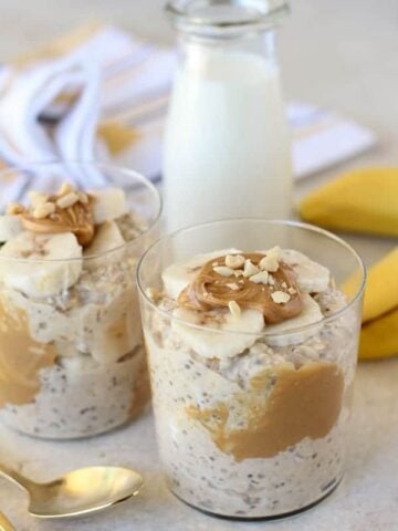 Overnight oats with peanut butter and sliced banana in a glass.