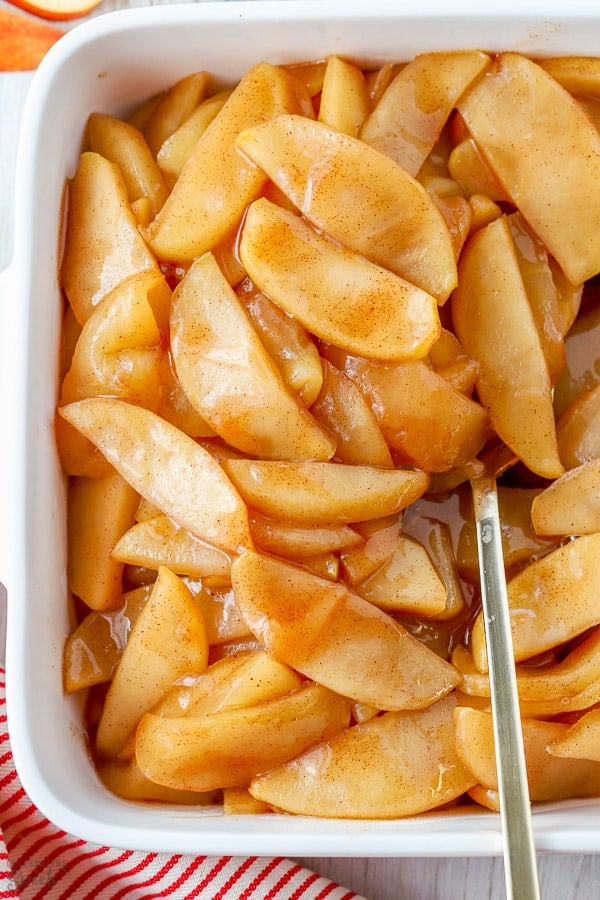 Cinnamon Apples in a white baking dish.