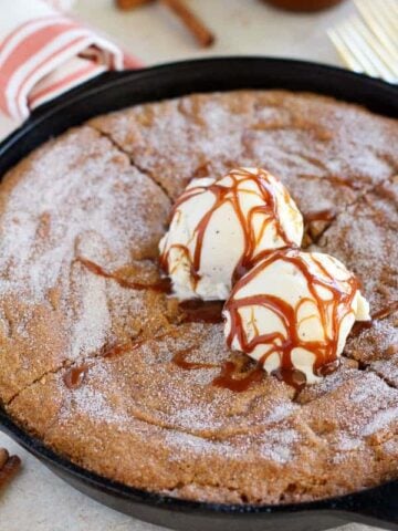 Skillet cookie topped with ice cream and caramel.