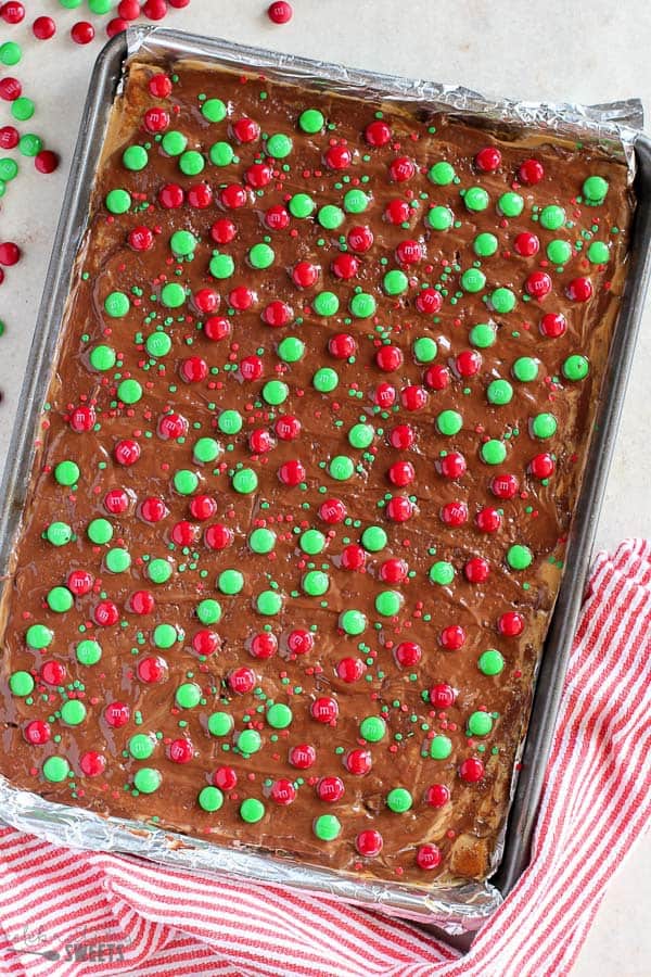 This festive Christmas Bark is easy and delicious! Layers of graham crackers, brown sugar toffee, peanut butter, and chocolate make this an addictive holiday treat.