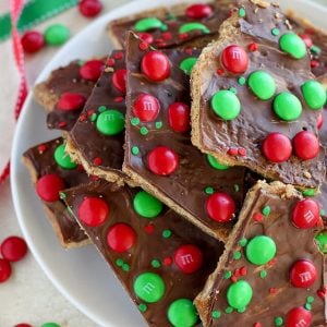 This festive Christmas Bark is easy and delicious! Layers of graham crackers, brown sugar toffee, peanut butter, and chocolate make this an addictive holiday treat.