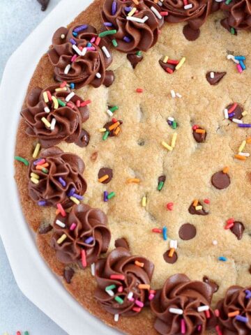 Chocolate Chip Cookie Pie topped with chocolate frosting and sprinkles.