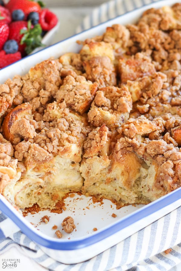 Baked french toast in a casserole dish with berries in the background