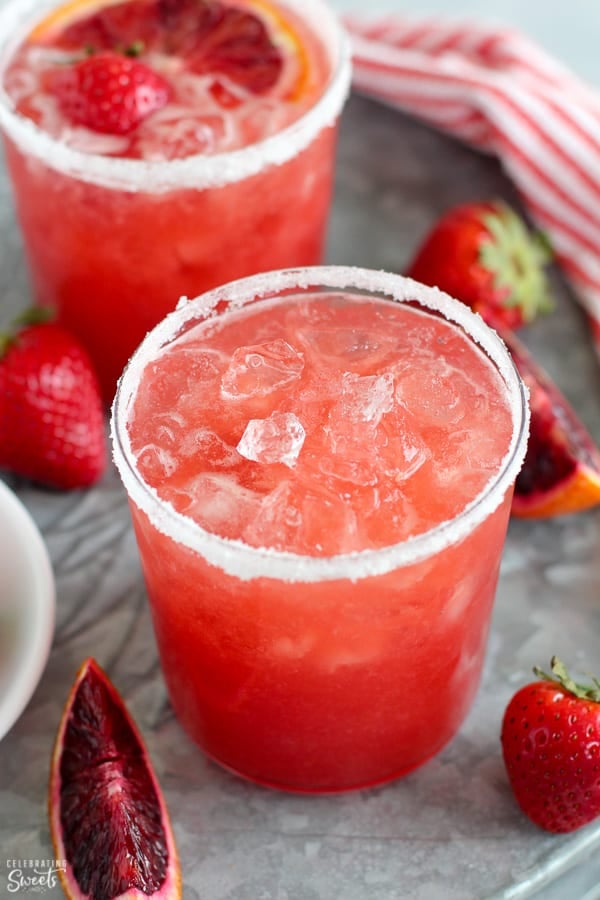 Strawberry margarita in a glass with crushed ice.