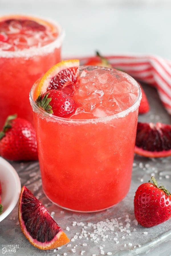 Strawberry margarita in a glass with crushed ice.