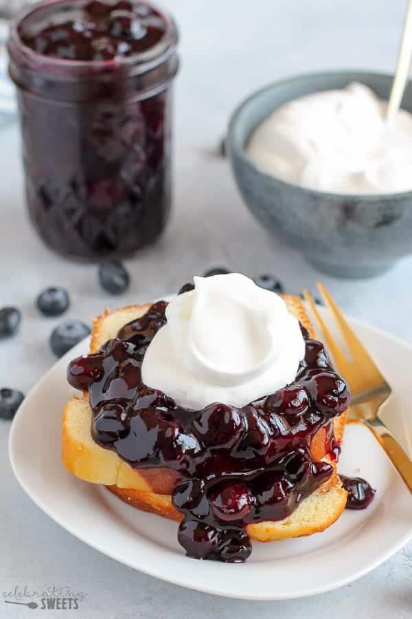 Blueberry Sauce on a Stack of Pound Cake with Whipped Cream.