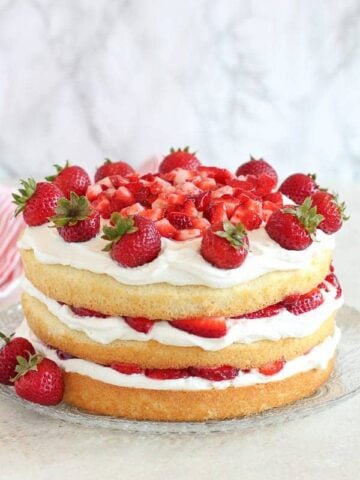 Strawberry Shortcake Cake topped with strawberries.
