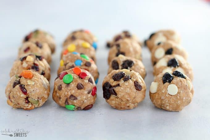 Four flavors of energy bites on a wood board.