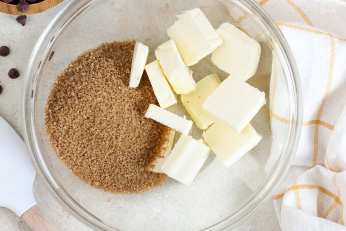 Butter and raw sugar in a glass bowl.