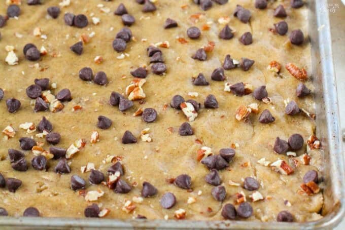 Unbaked chocolate chip cookie brittle on a baking sheet.