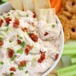 Bowl of artichoke dip with pita chips.