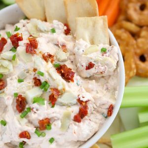 Bowl of artichoke dip with pita chips.