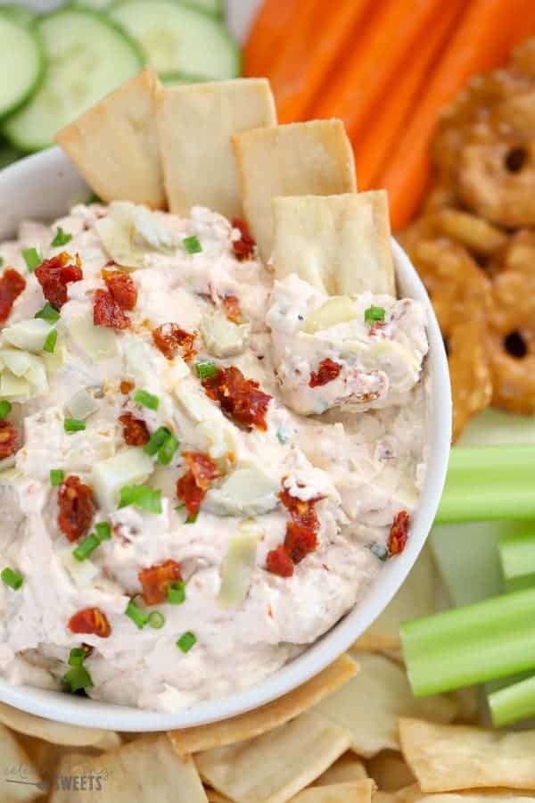 Bowl of artichoke dip with pita chips.