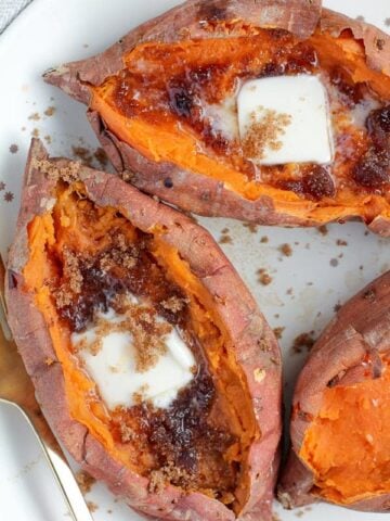 Baked Sweet Potatoes topped with butter and brown sugar.