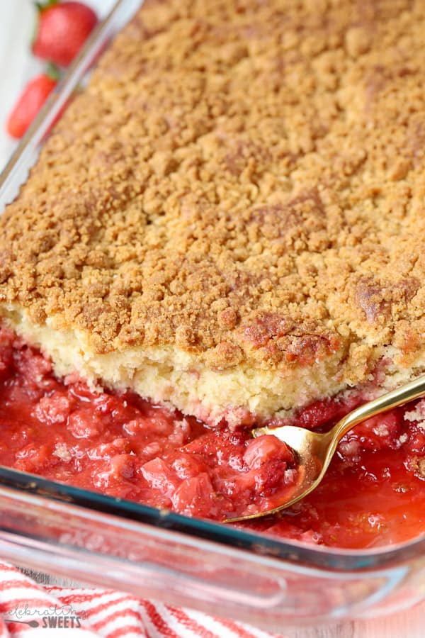 Strawberry Crumb Cake in a baking dish with a gold spoon.