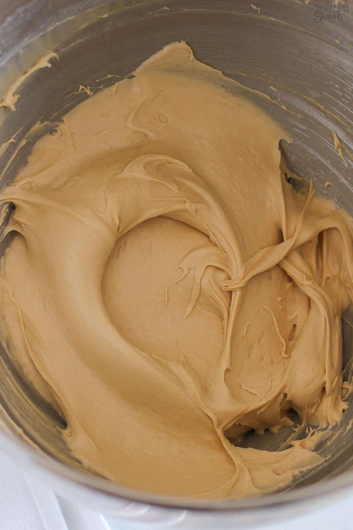 Brown sugar cream cheese frosting in a stainless steel bowl.