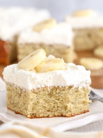 Slice of banana cake on a white plate.