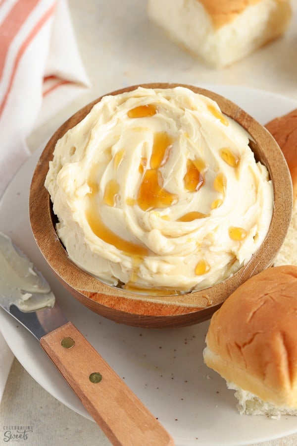 Maple butter in a brown bowl drizzled with maple syrup.