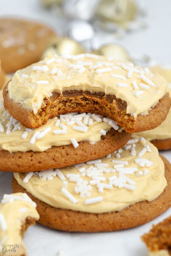 Stack of three molasses cookies topped with frosting.