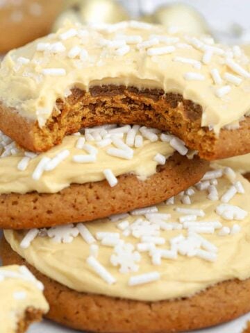 Three molasses cookies topped with frosting.