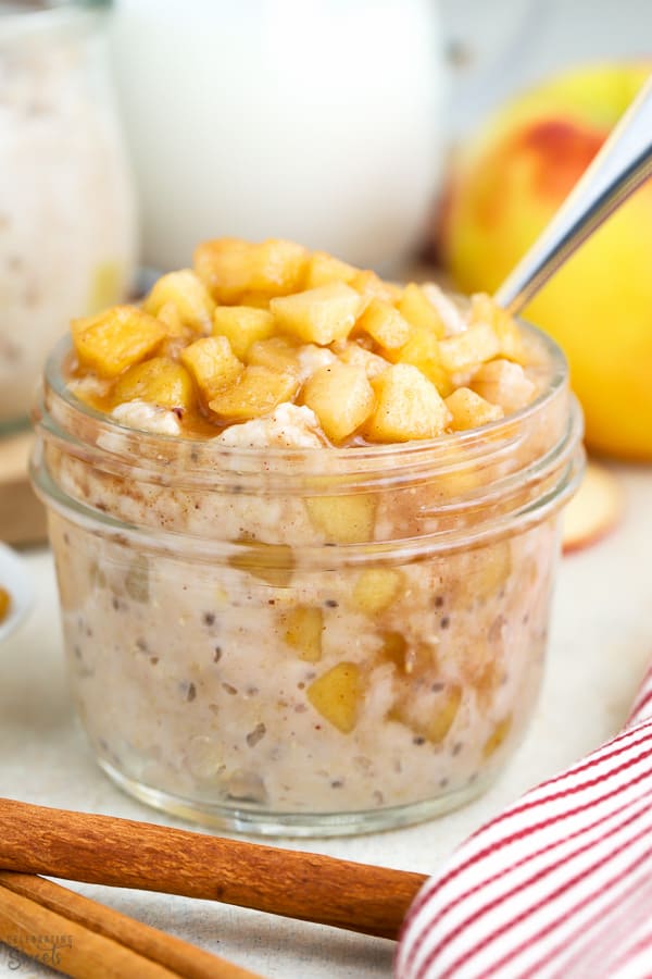 Overnight oats in a jar topped with cinnamon apples.