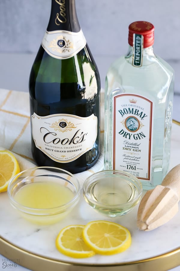 Ingredients to make French 75: champagne, gin, lemon juice, sugar.