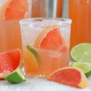 Grapefruit cocktail garnished with lime.