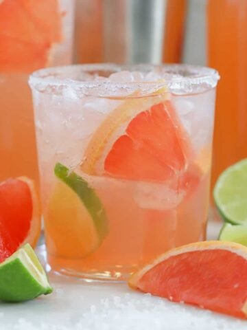 Grapefruit cocktail garnished with lime.