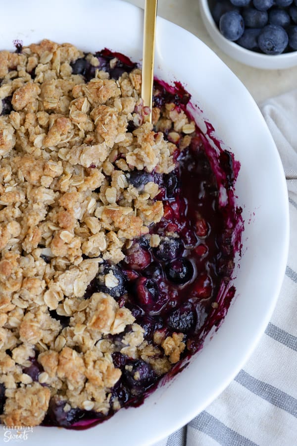 Close up of Blueberry Crisp in a white pie plate.