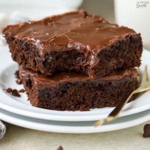 Two brownies on a white plate.