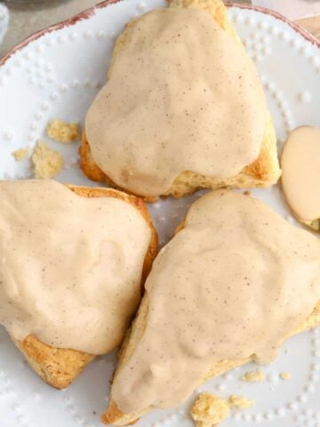 Three maple scones on a plate.