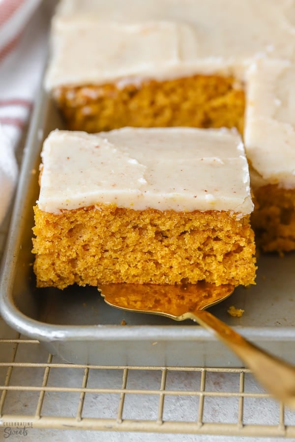A square slice of pumpkin bar in a grey sheet pan.