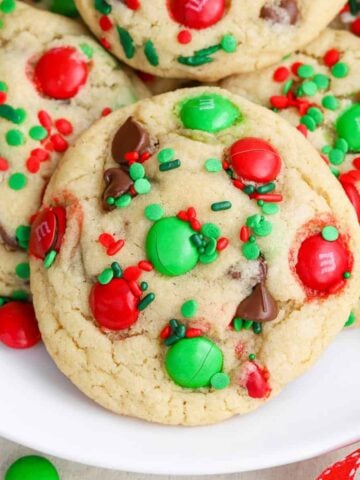 Christmas cookies on a plate with red and green sprinkles and candies