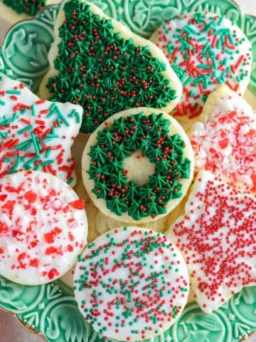 Christmas cut out cookies on a green plate