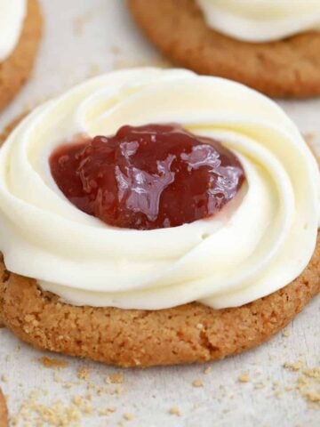 Cheesecake cookie with a swirl of frosting and jam in the center