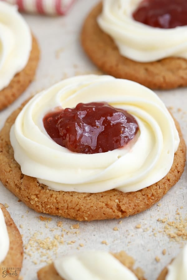 Cheesecake cookie with a swirl of frosting and jam in the center
