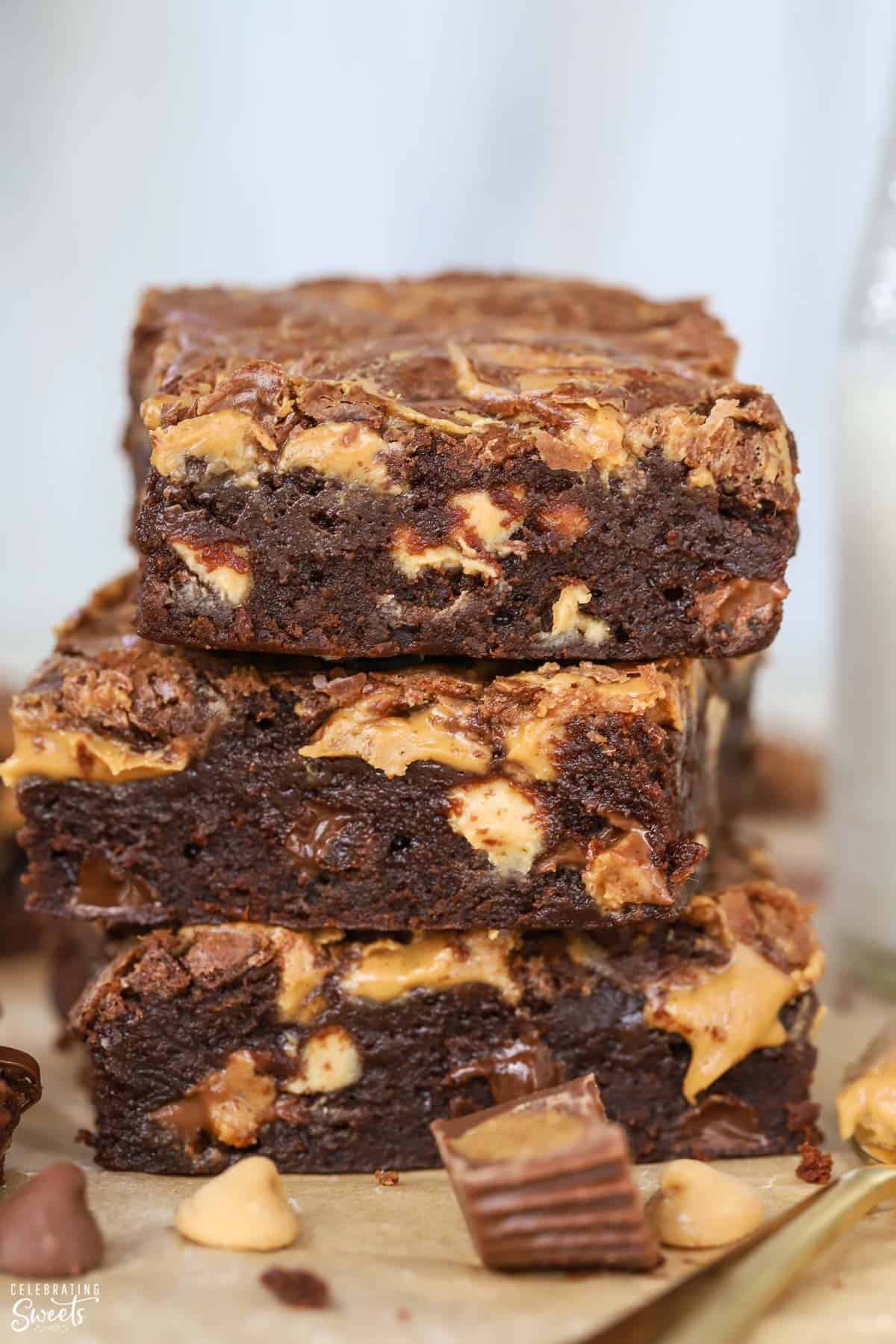 Stack of three peanut butter brownies on parchment paper
