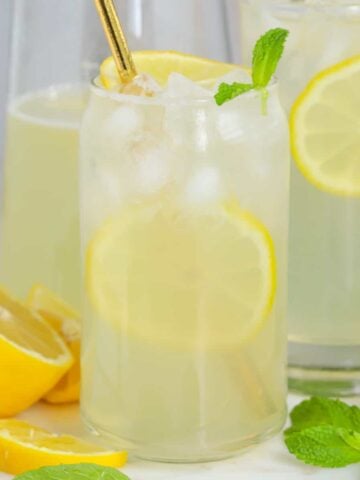 Glasses of lemonade garnished with lemon slices and mint.