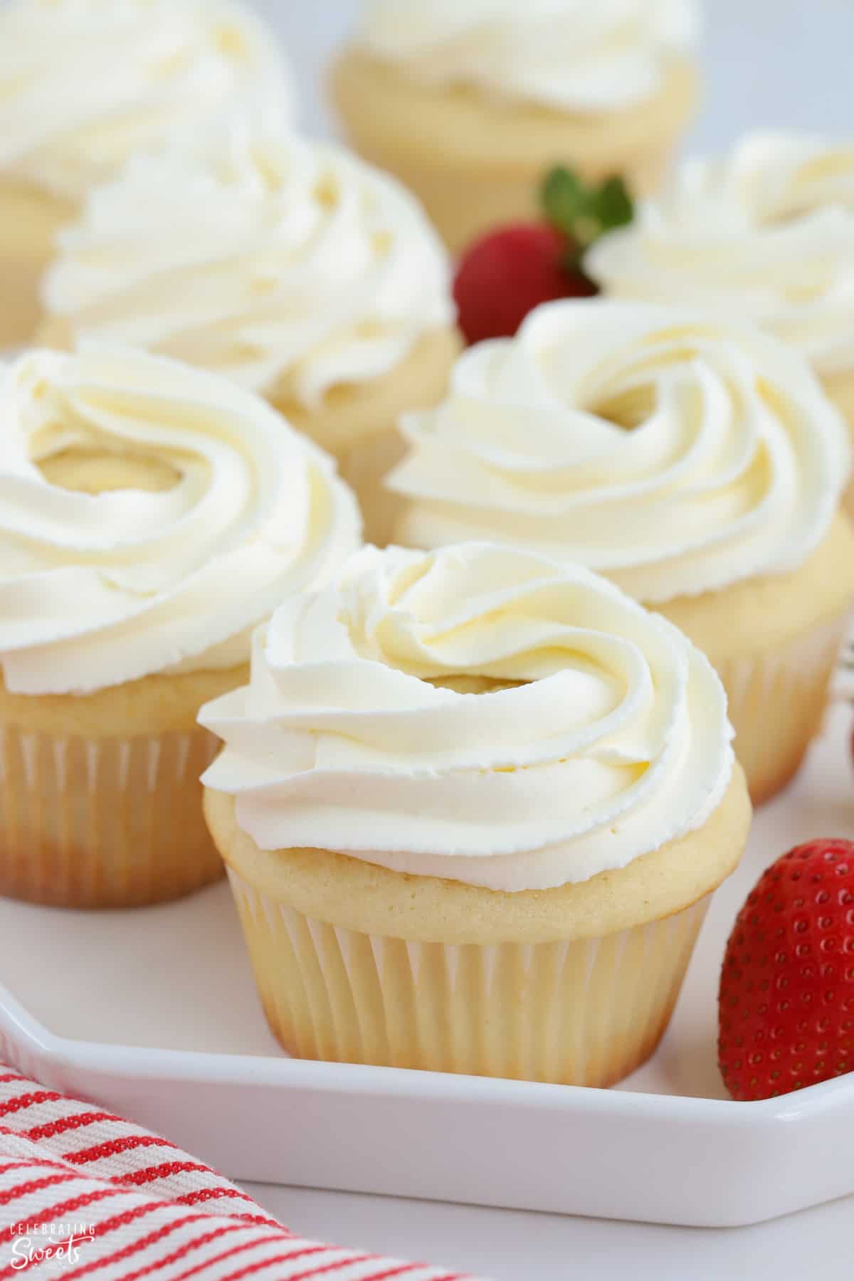 Closeup of vanilla cupcake with swirled white frosting