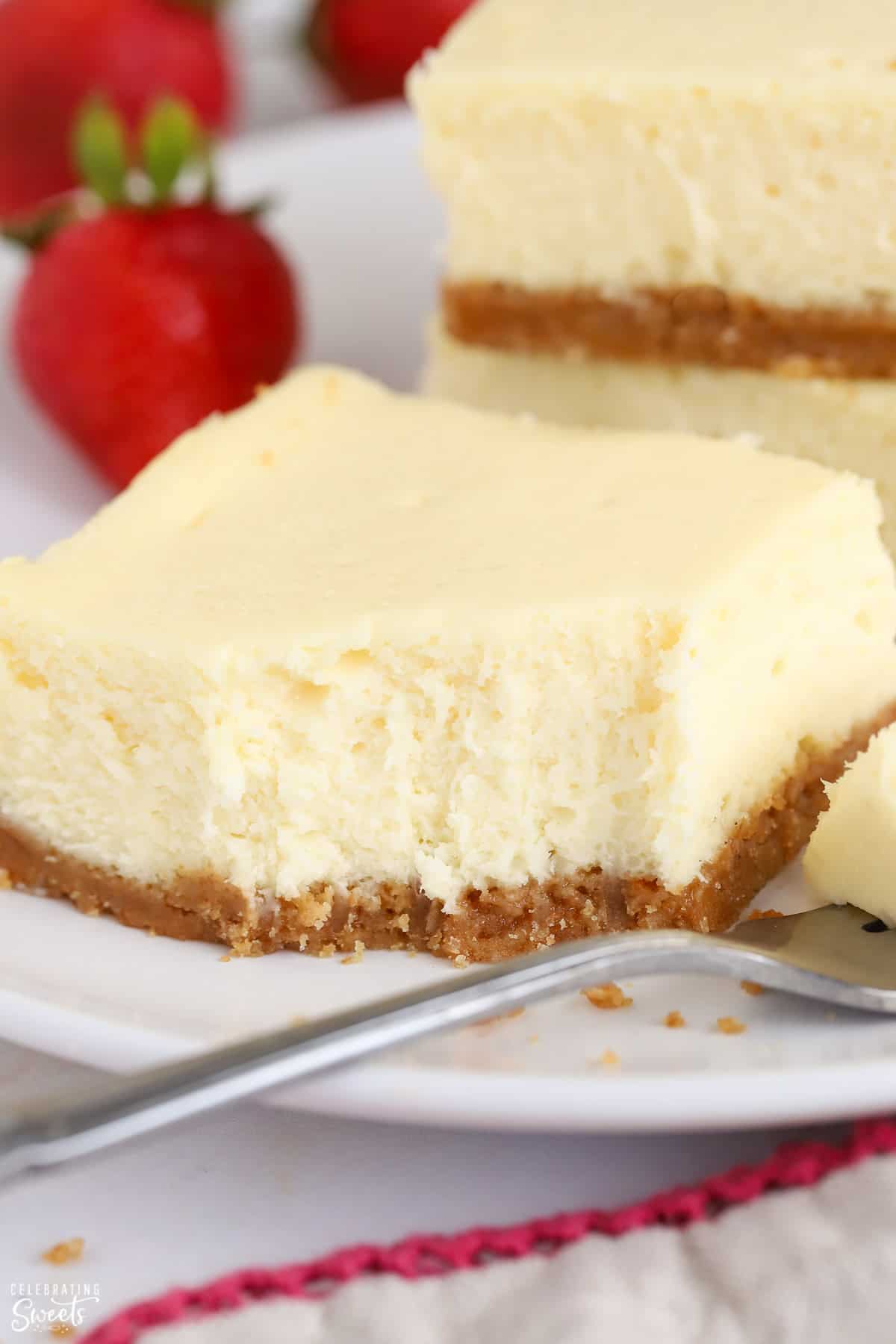 Cheesecake bar on a white plate with a fork