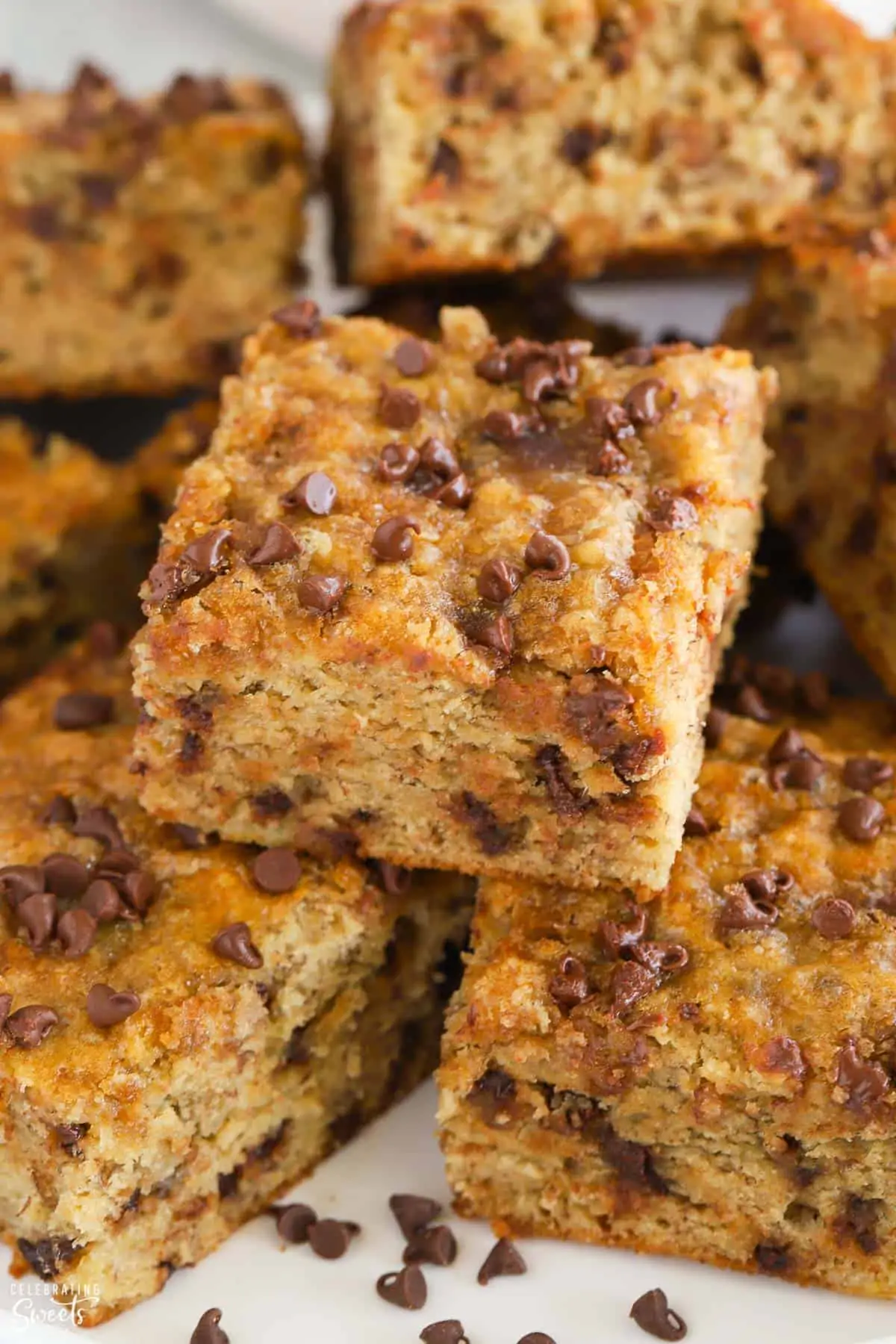 Square pieces of chocolate chip banana bread on a plate.