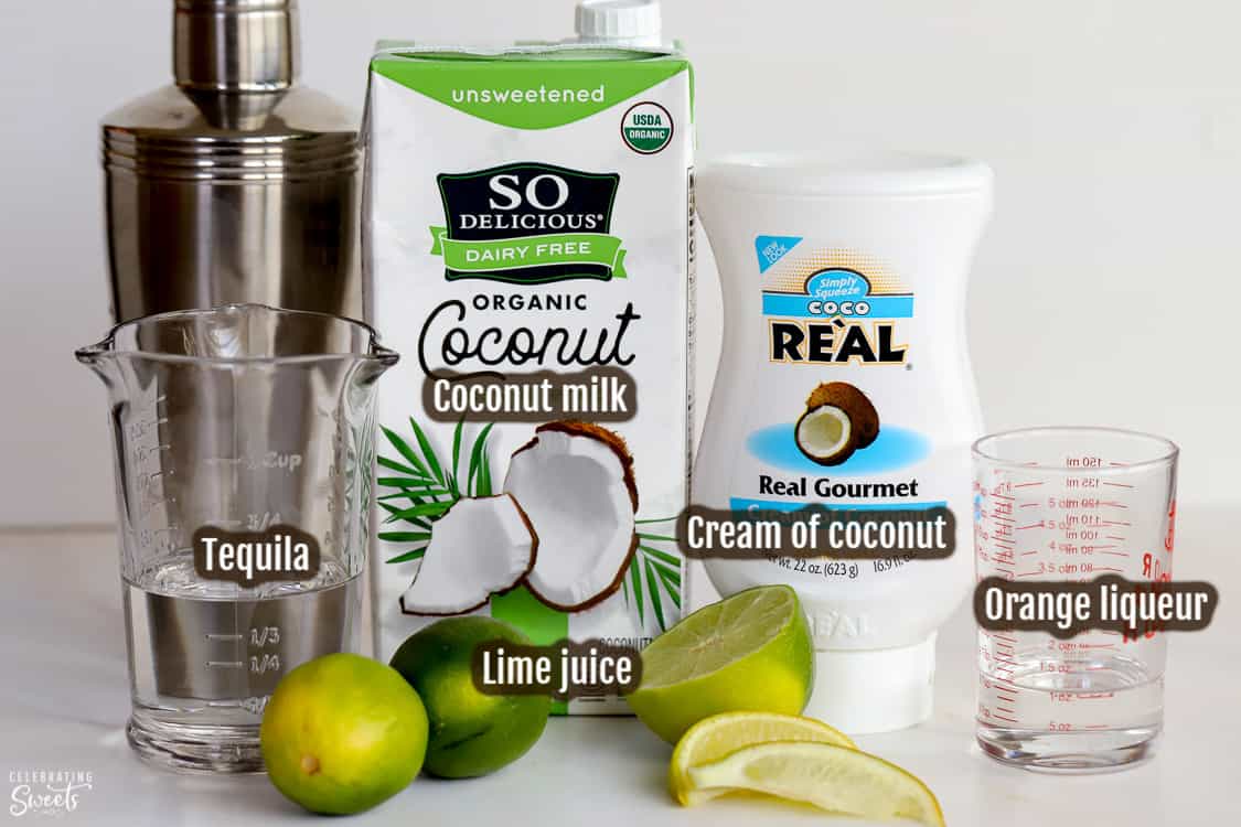 Ingredients for making coconut margaritas (tequila, triple sec, limes, coconut milk)