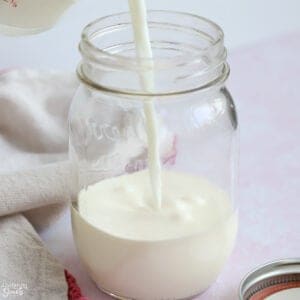 Milk being poured into a jar