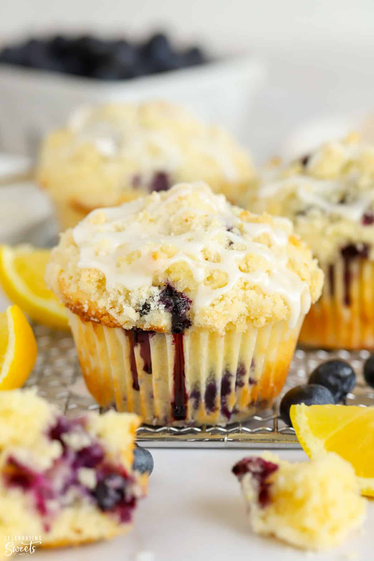 Closeup of a lemon blueberry muffin with crumb topping and white icing
