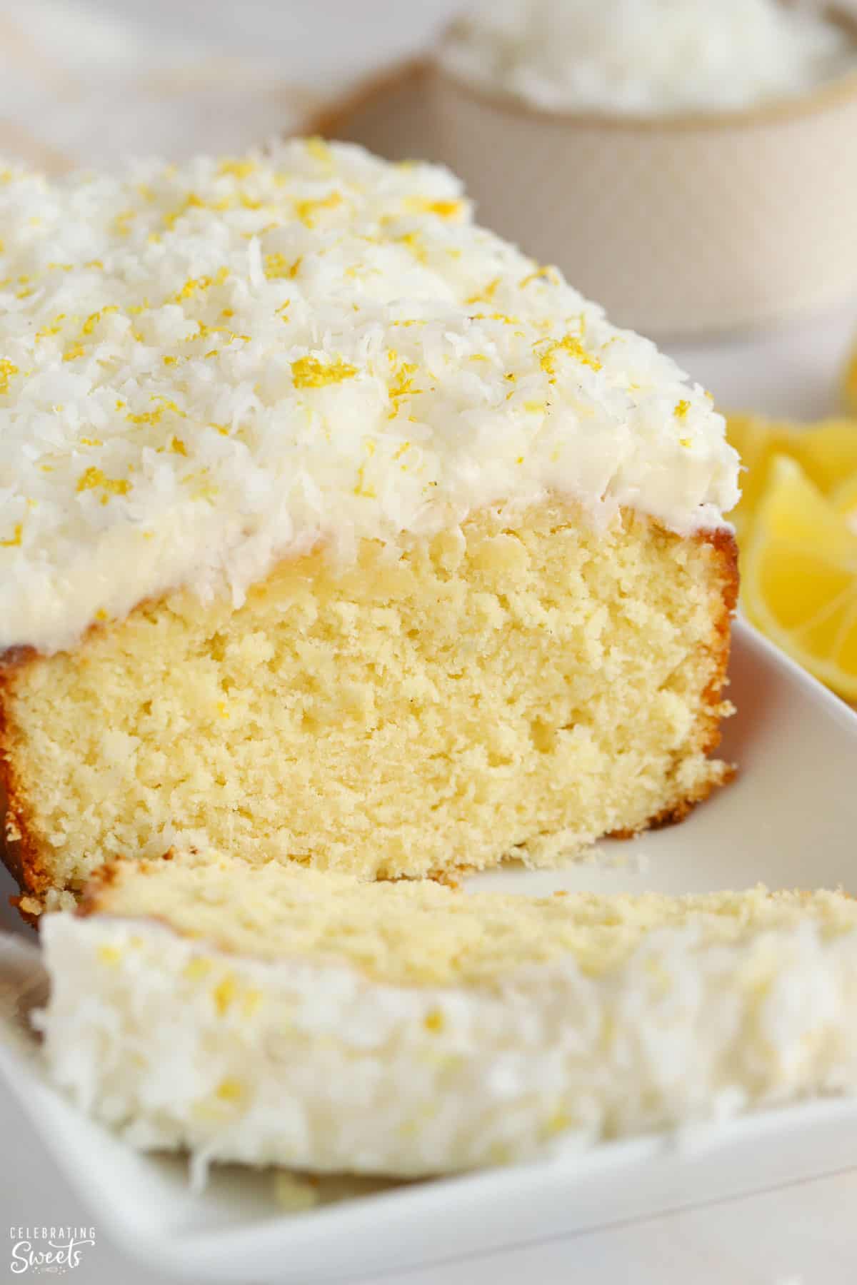 Lemon Coconut loaf cake topped with frosting and shredded coconut