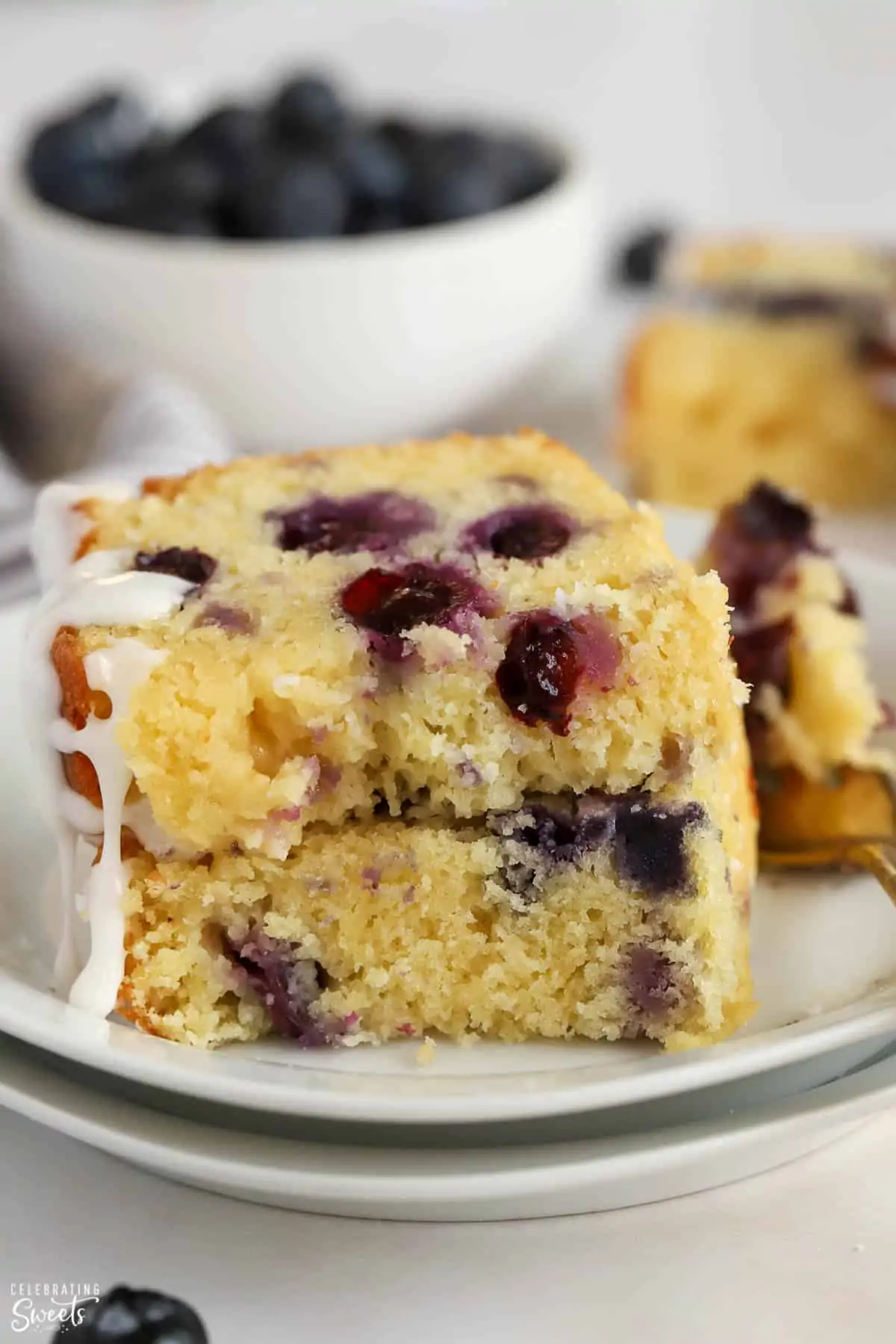 Slices of blueberry bead stacked on a white plate.