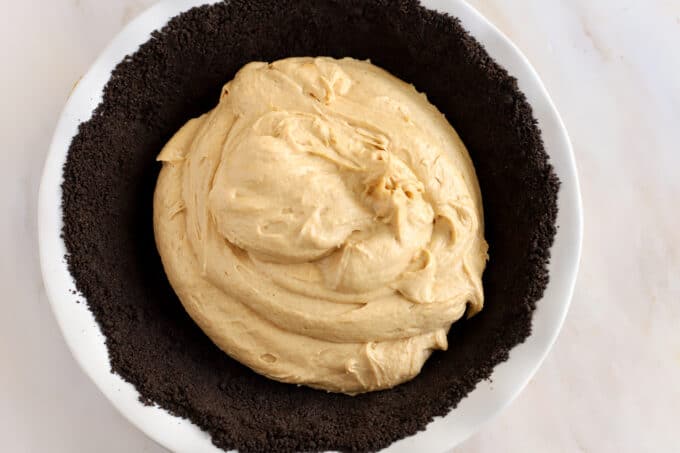 Creamy peanut butter pie filling inside an Oreo cookie crust.
