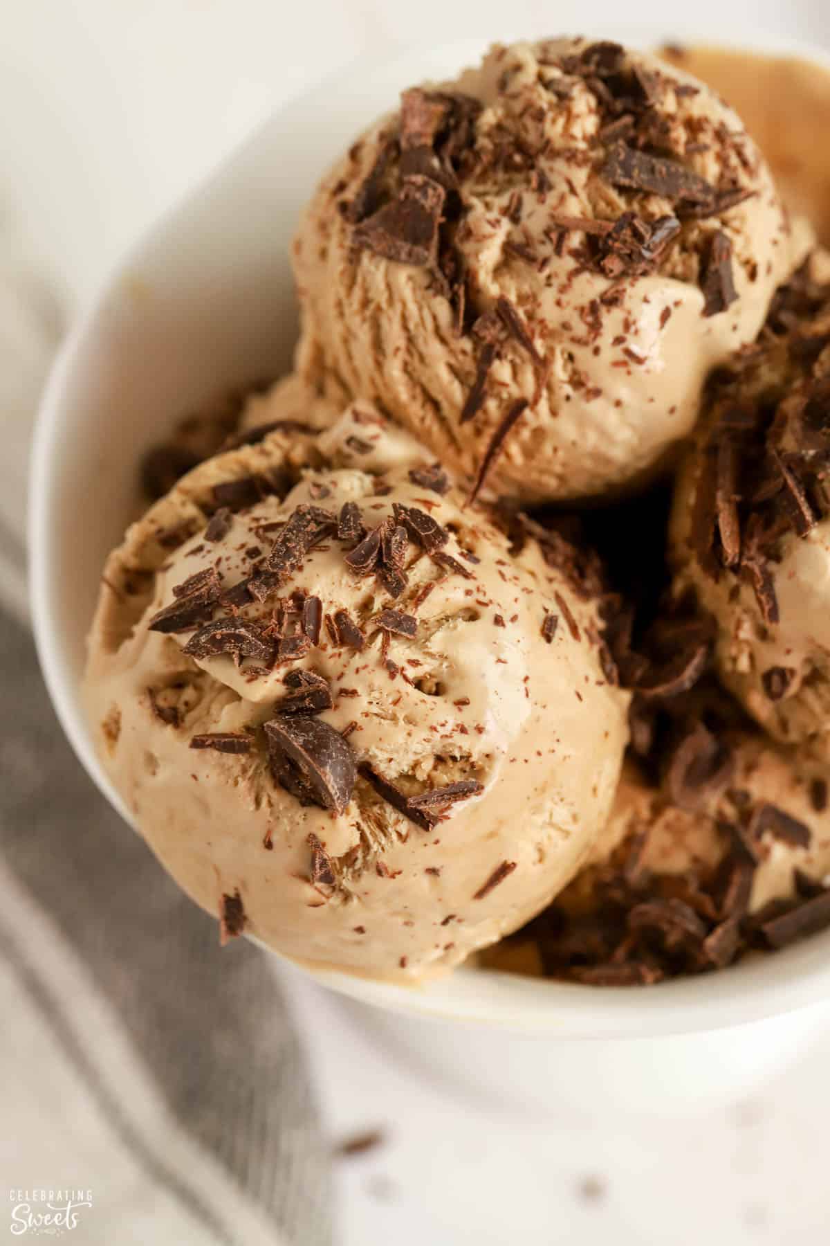 Coffee Ice Cream in a white bowl topped with chopped chocolate.